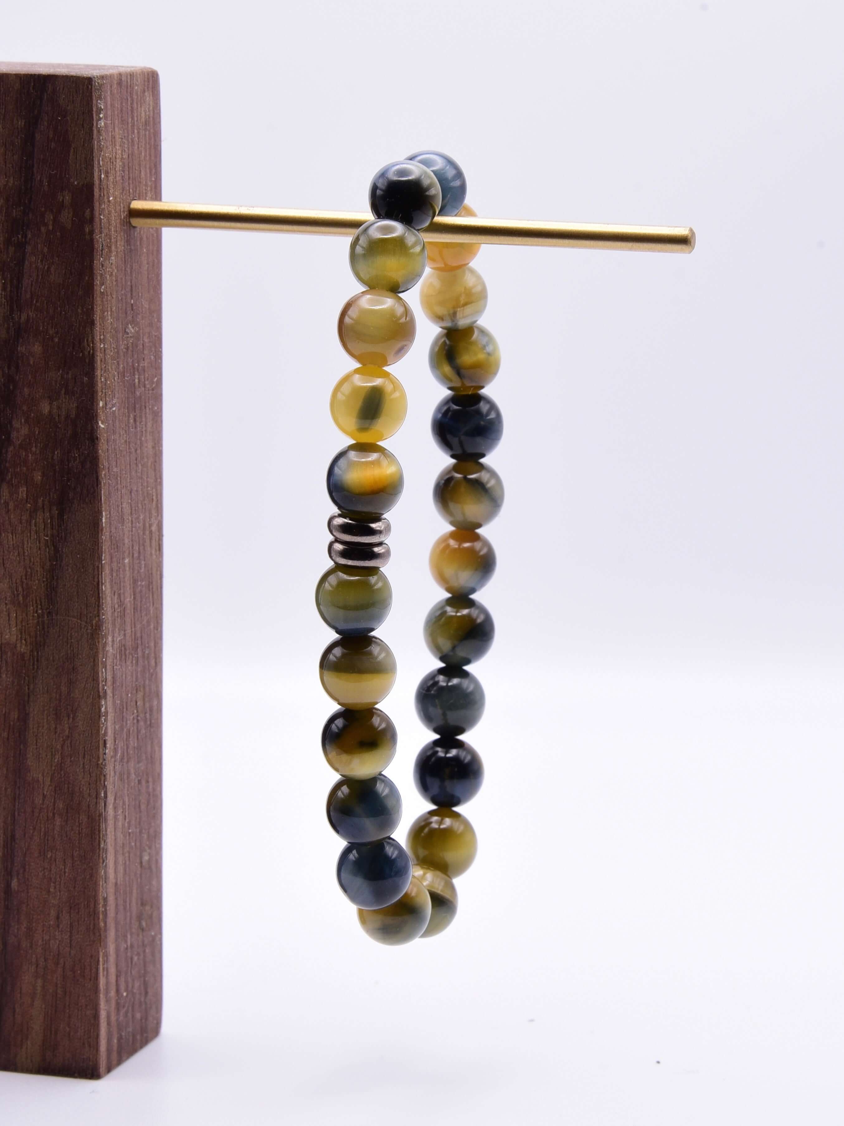 Blue and Blonde Tiger Eye Bead Bracelet This bracelet is made with high-quality Blue and Blonde Tiger Eye stones which bring confidence and optimism to the wearer. Zodiac Signs: Leo and Capricorn. Chakras: Root and Solar Plexus. Handmade with authentic cr