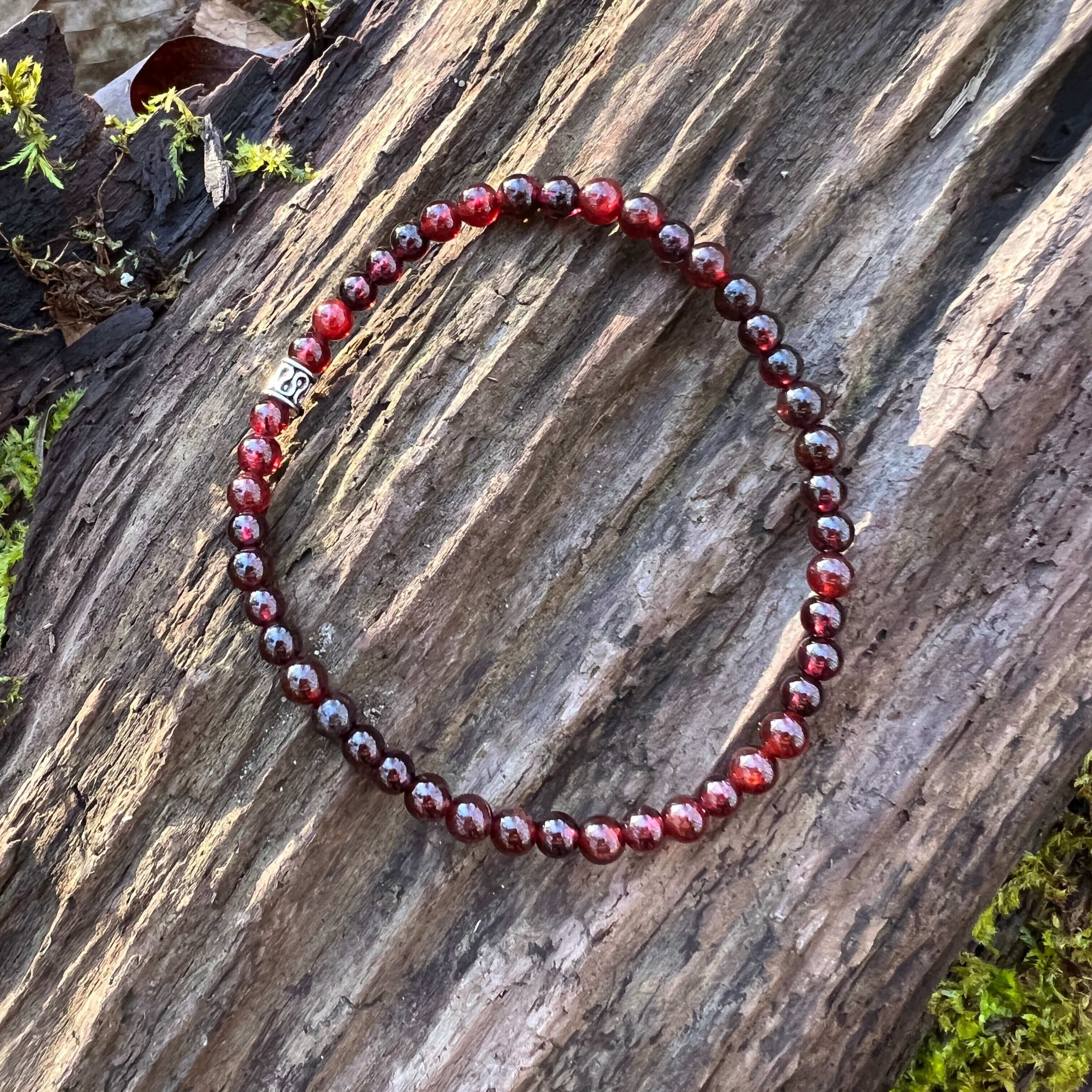 Garnet Bead Bracelet This bracelet is made with high-quality Garnet stones which bring hope and courage to the wearer. Zodiac Signs: Aquarius, Aries, Sagittarius, Leos and Capricorn. Chakras: Sacral, Root. Birthstone: January. Anniversary: 2nd. Handmade w