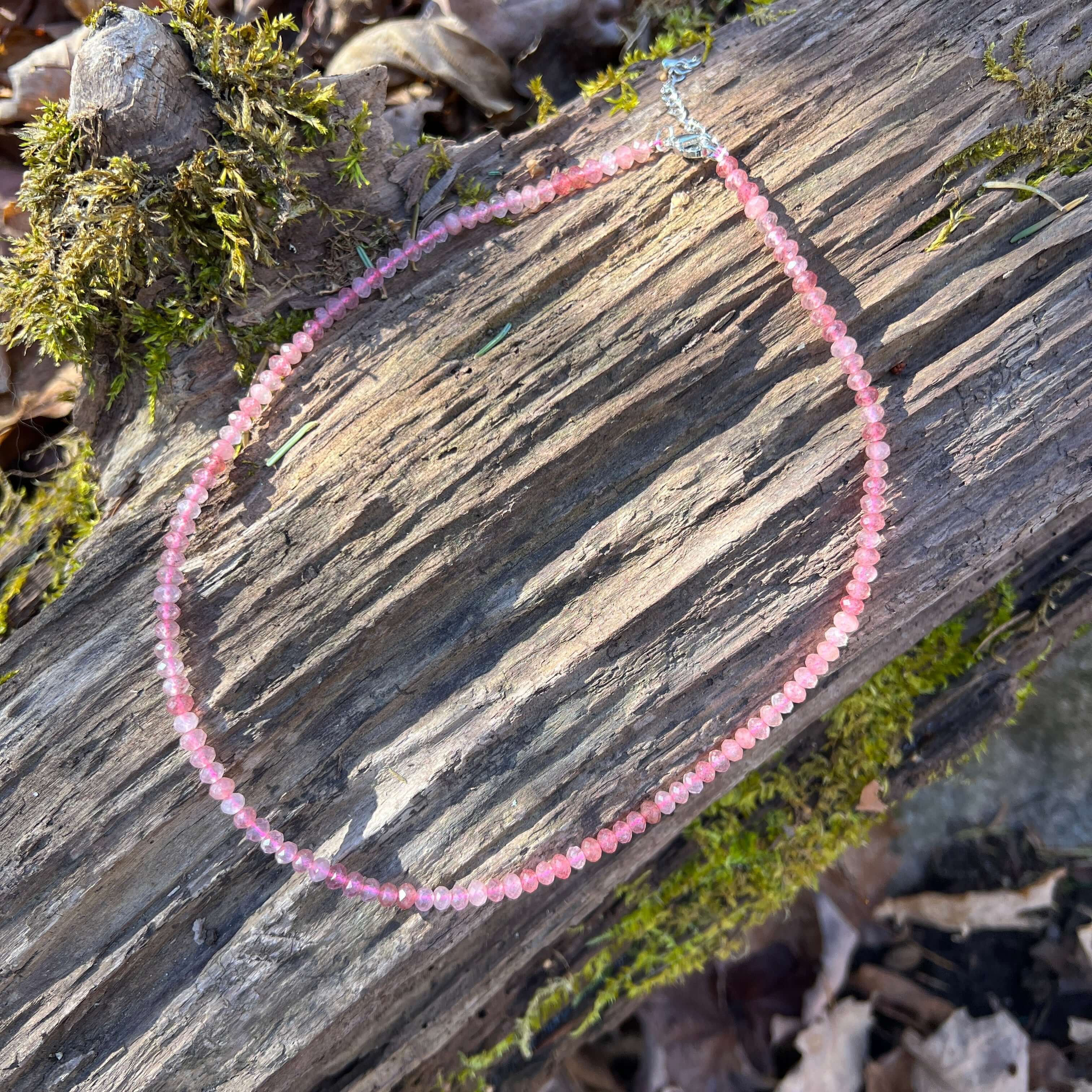 Strawberry Quartz Necklace This necklace is made with high-quality Strawberry Quartz gemstones which bring self-compassion and positive energy to the wearer. This beautiful pink stone is cut in a dainty, faceted rondelle shape which brings a sense feminin