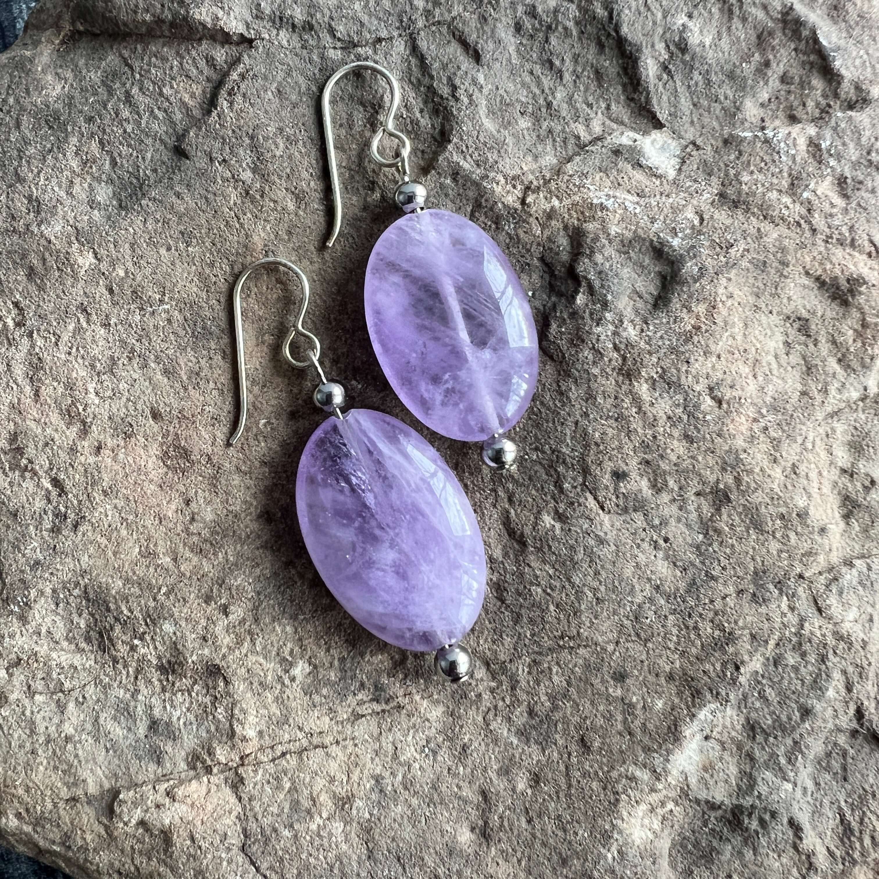 Lavender Amethyst Earrings These earrings are made with high-quality Amethyst stones which bring serenity to the wearer. Amethyst is a stone of serenity. This stone helps to calm the mind. It was once known as a “Gem of Fire” by ancient cultures. It has b