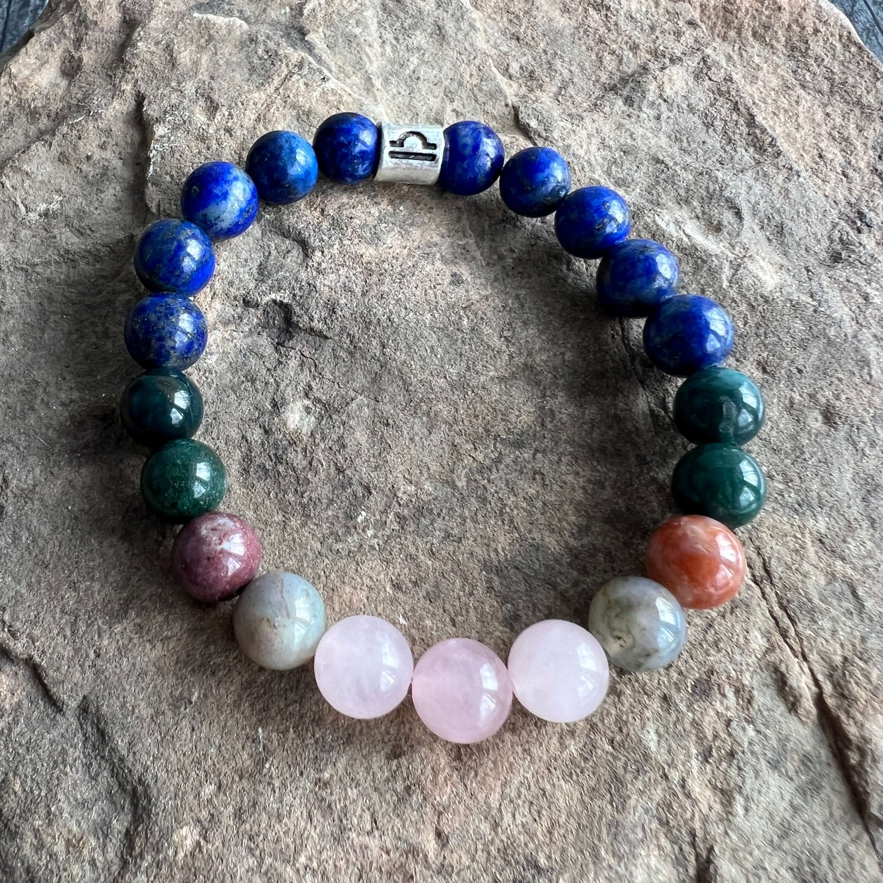 Libra Zodiac Bracelet The Libra Zodiac Bracelet is created with a combination of Rose Quartz, Agate and Lapis beads, which resonate with the graceful and harmonious qualities associated with this zodiac sign.