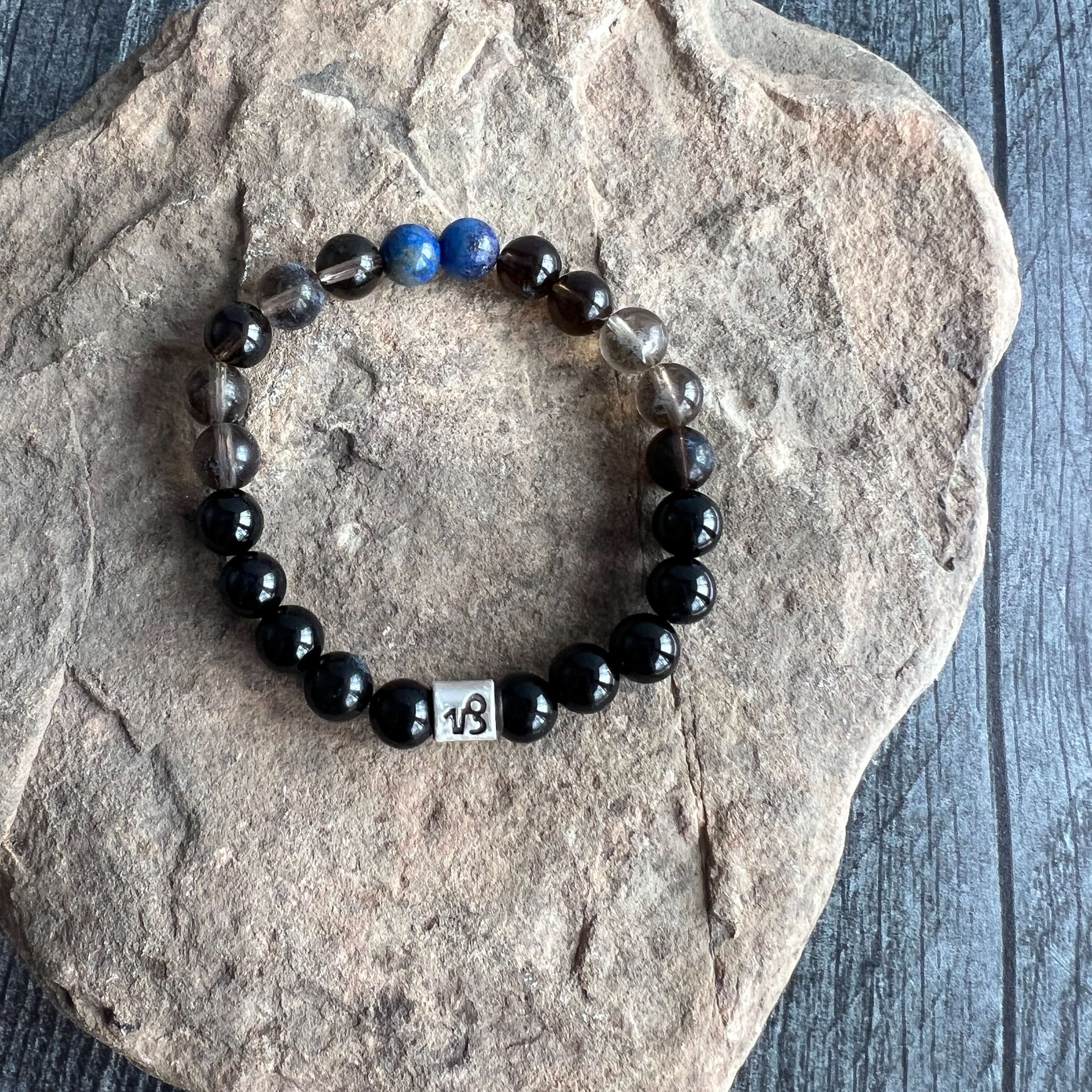 Capricorn Zodiac Bracelet The Capricorn Zodiac Bracelet is created with a combination of Lapis Lazuli, Smoky Quartz, and Onyx beads, which resonate with the strong and determined qualities associated with this zodiac sign.
