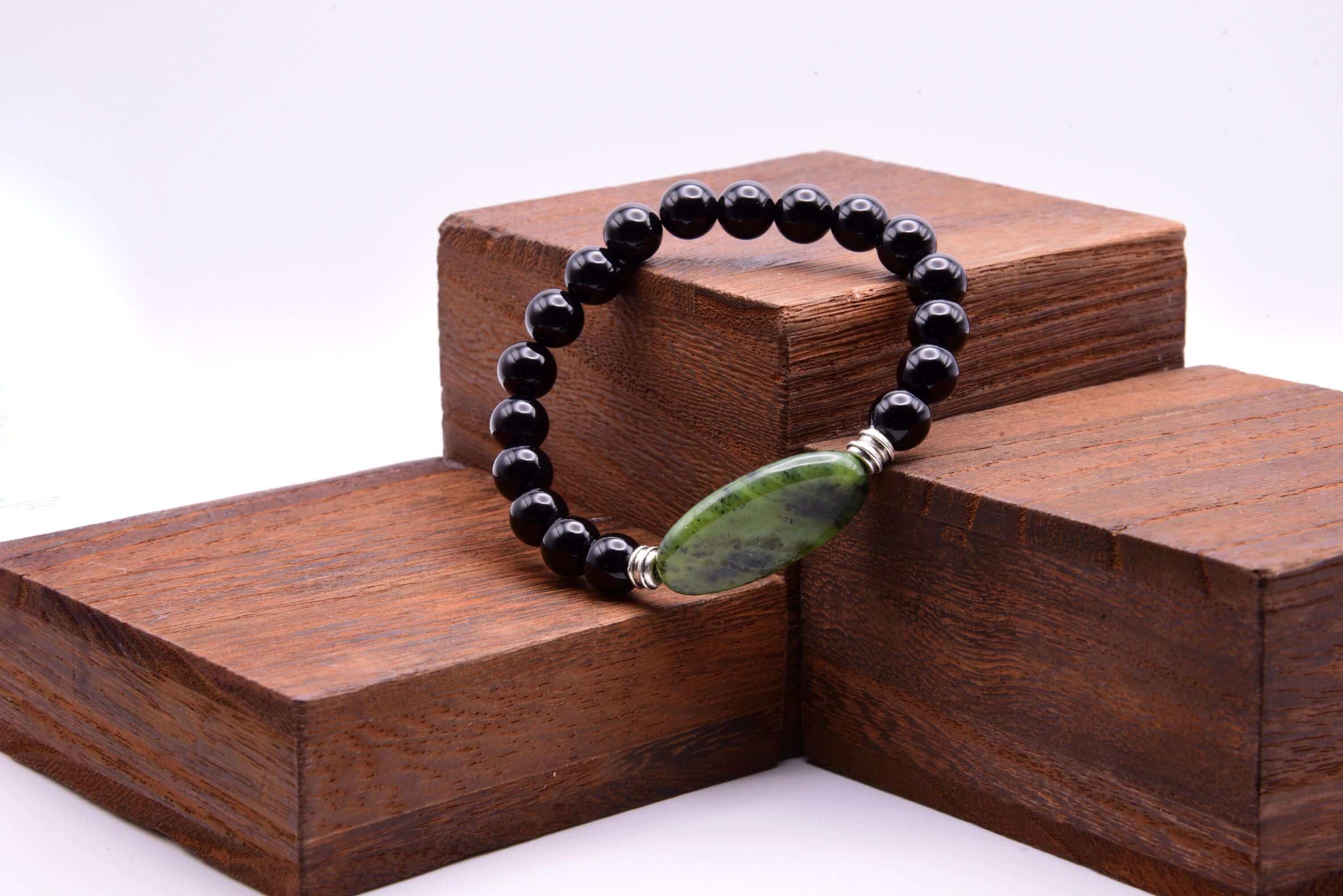 Jade Focal Bracelet This bracelet is made with high-quality Jade and either Black Onyx or Obsidian stones which bring calm and insight to the wearer. Zodiac Signs: Capricorn, Gemini, Libra, Taurus, and Virgo. Chakra: Heart. Handmade with authentic crystal
