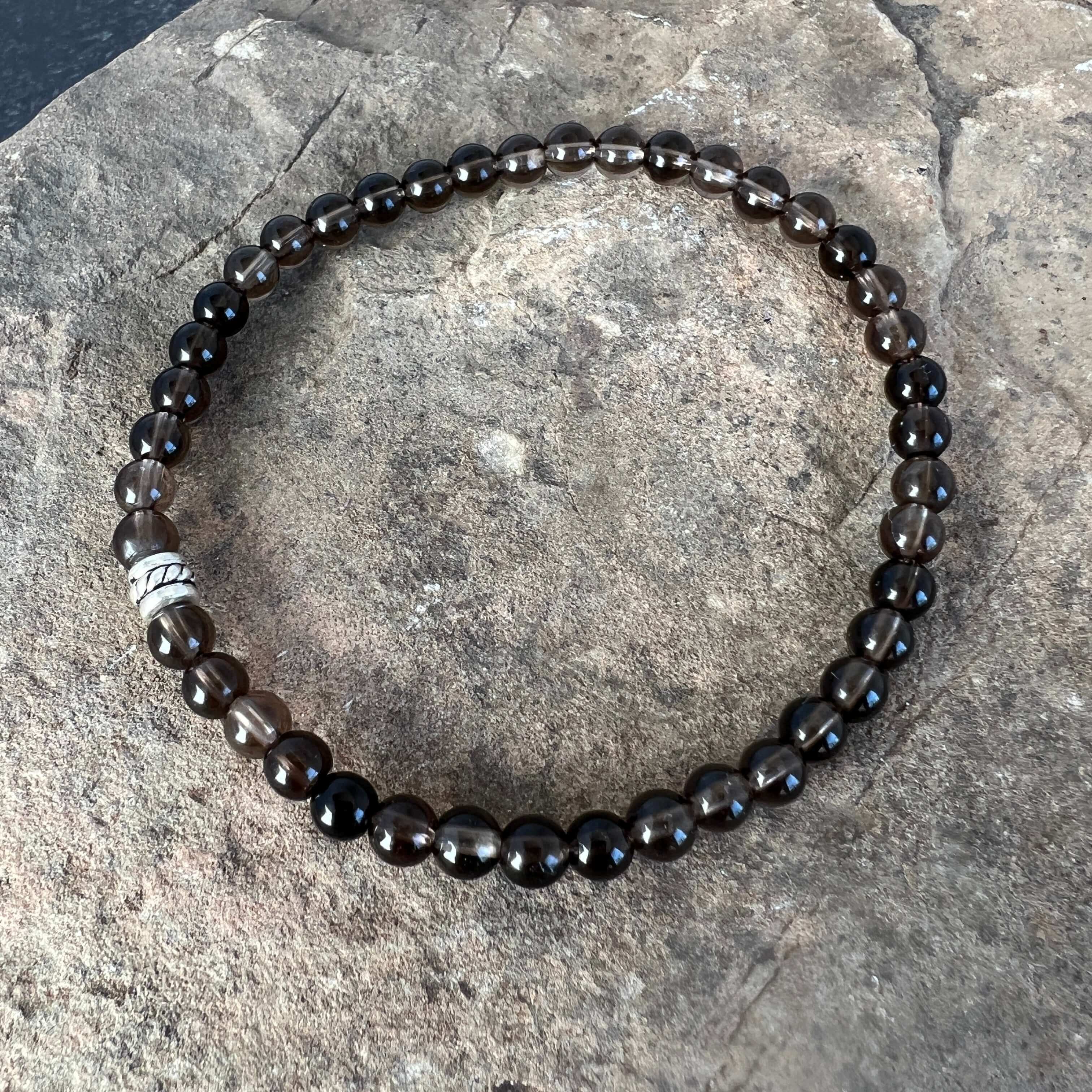 Smoky Quartz Bracelet This bracelet is made with high-quality Smoky Quartz gemstones which bring stress relief and protection from negativity to the wearer. Zodiac Signs: Scorpio, Sagittarius, and Capricorn. Chakras: Root and Solar Plexus. Handmade with a