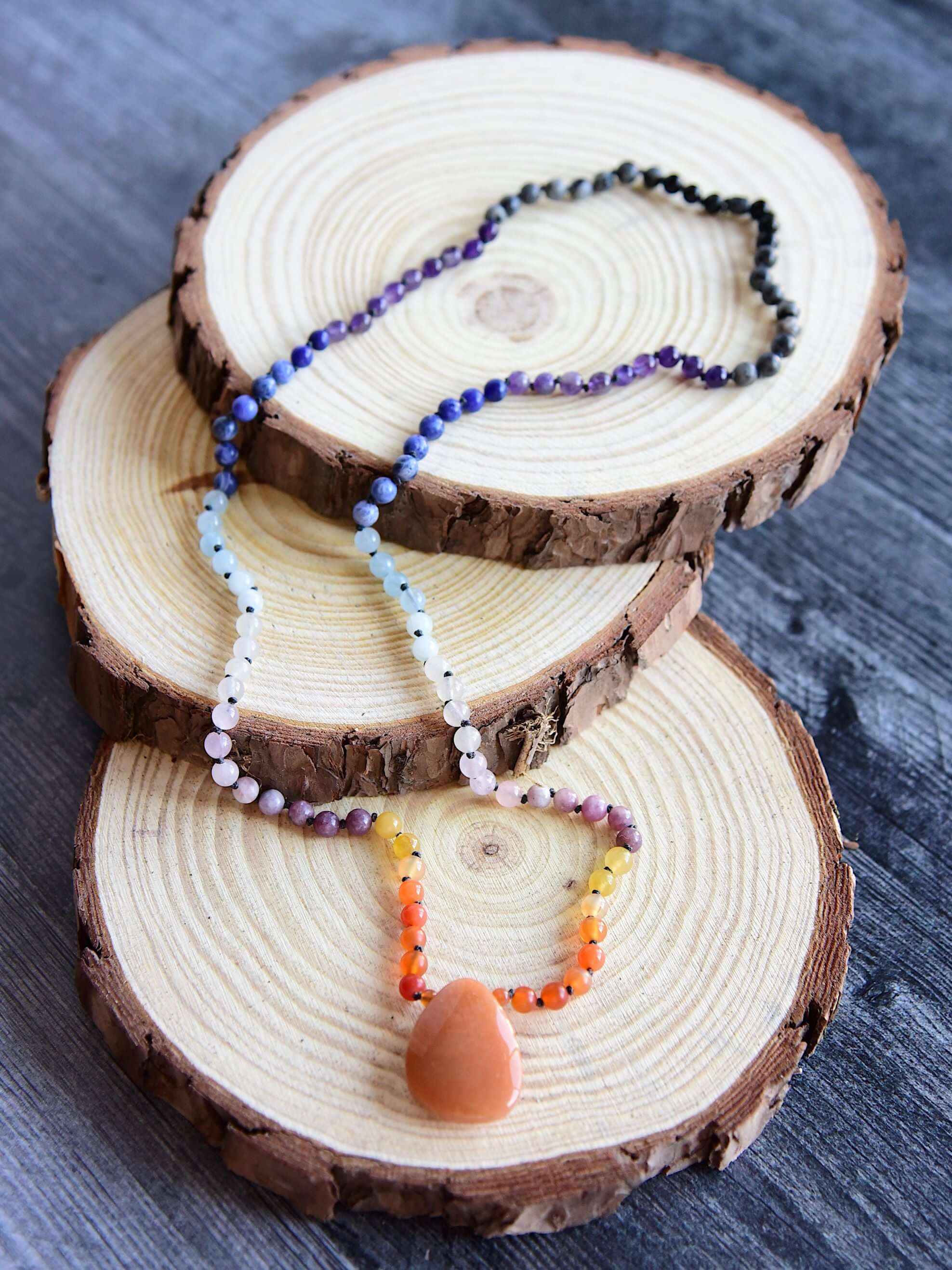 Sunset Mala This mala is made with authentic Carnelian, Yellow Jade, Lepidolite, Moonstone, Aquamarine, Sodalite, Amethyst, Larvikite, Red Aventurine, and Onyx gemstones which give the wearer a sense of being deeply rooted. Zodiac Signs: All. Chakras: All