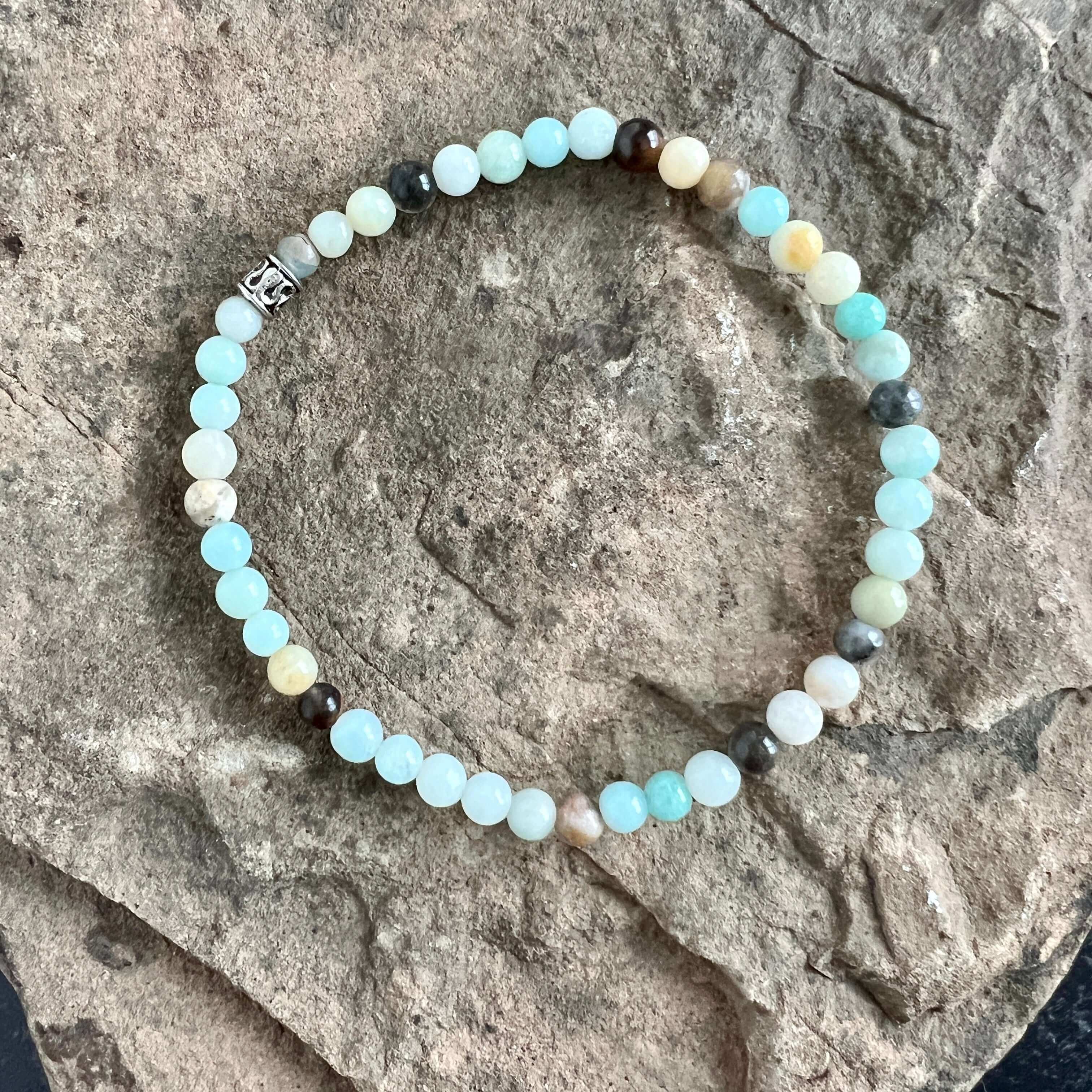 Black Gold Amazonite Bracelet This bracelet is made with high-quality Black Gold Amazonite stones which bring inspiration and calm to the wearer. Zodiac Sign: Virgo. Chakras: Heart and Throat. Handmade with authentic crystals and gemstones in Minneapolis,
