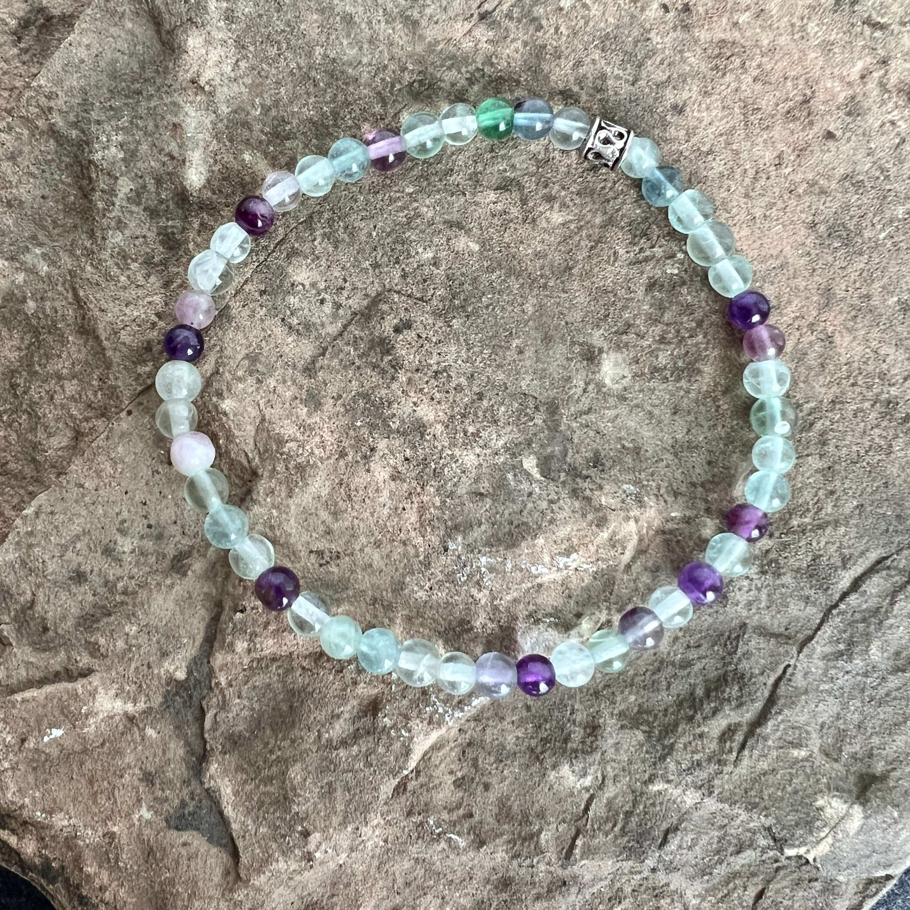 Fluorite and Amethyst Bead Bracelet This bracelet is made with high-quality Fluorite and Amethyst stones which bring stability, protection and awareness to the wearer. Zodiac Sign: Capricorn. Chakra: Heart. Handmade with authentic crystals and gemstones i