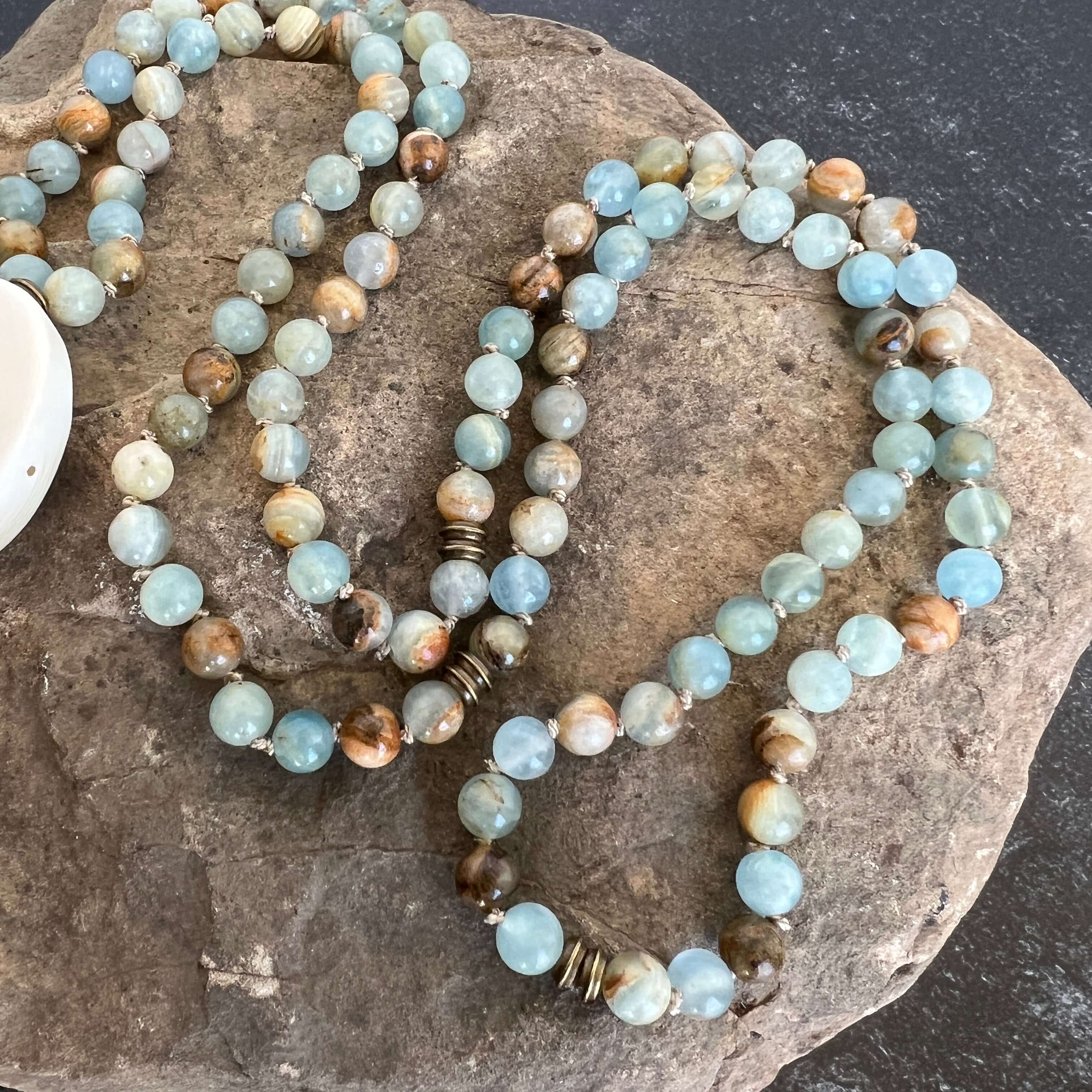 Lemurian Aquatine Calcite Mala The name of this particular calcite probably came about because of its distinct ocean blue and tan bands, denoting a strong land/water connection. Also known as Blue Argentinian Calcite, Argentinian Blue Onyx and Argentinian