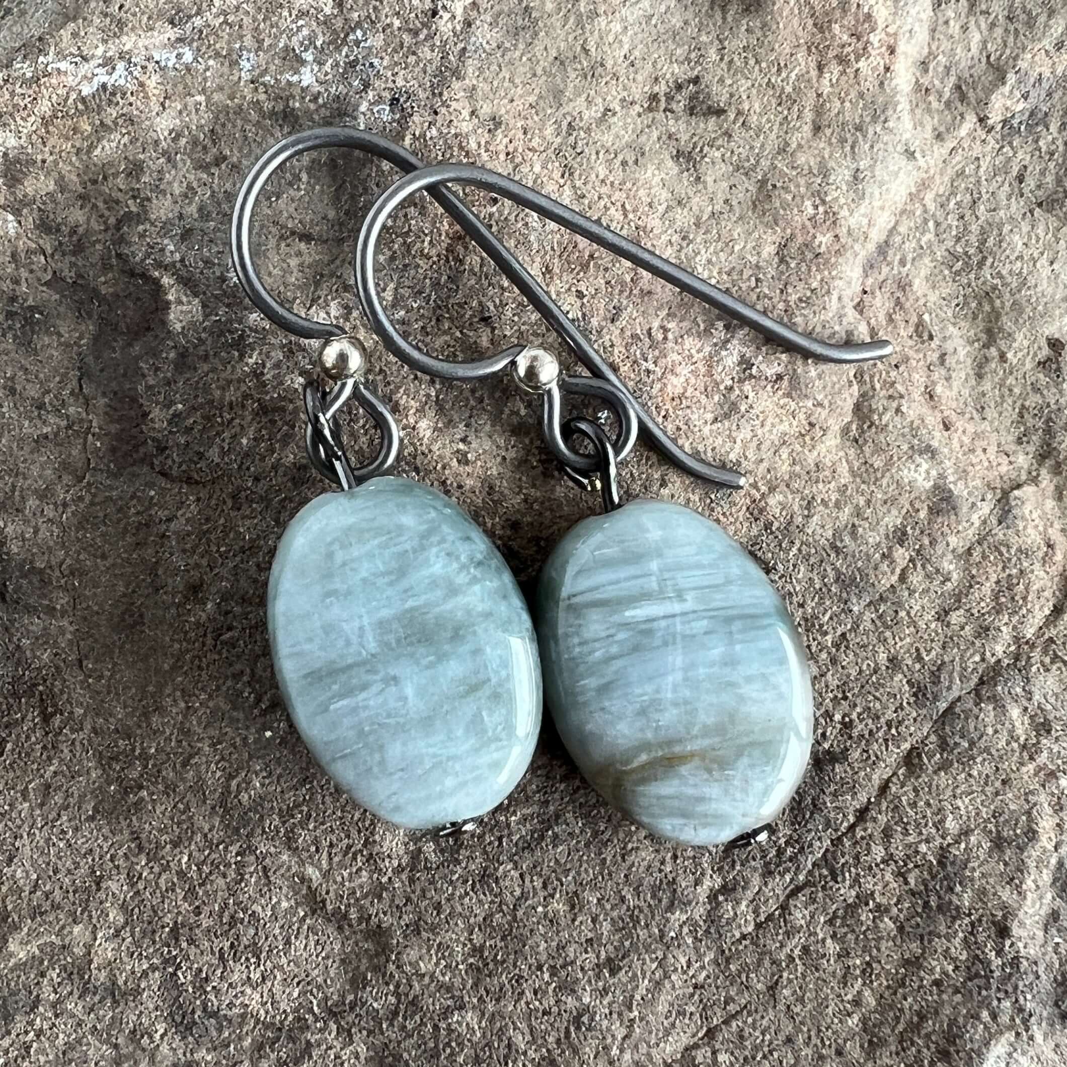 Cat's Eye Earrings These earrings are made from Cat's Eye stones which attract prosperity while protecting from negativity. Zodiac Signs: Aries. Chakras: Root, Solar Plexus & Third Eye. Handmade with authentic crystals & gemstones in Minneapolis, MN.