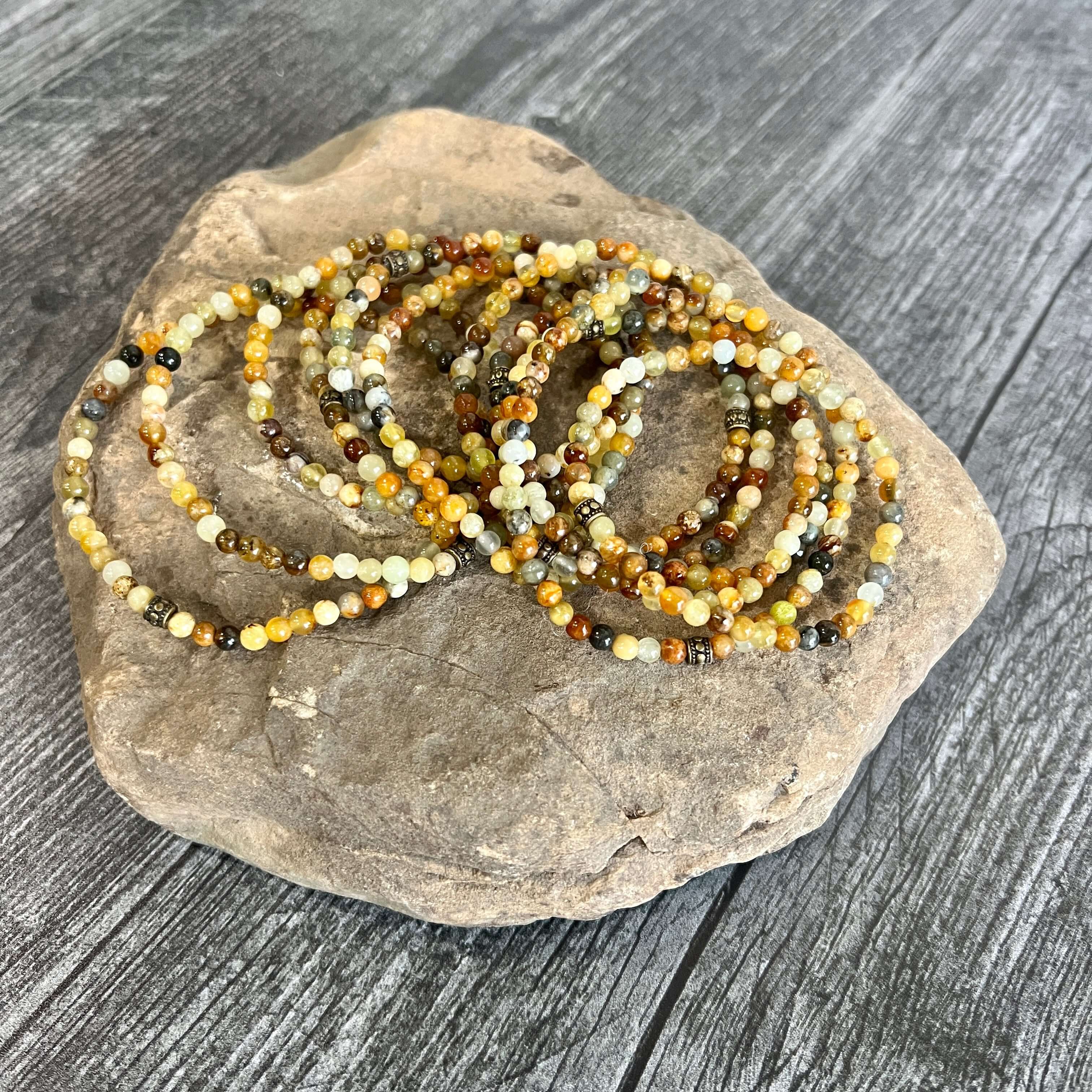 Flower Jade Mini Bead Bracelet This bracelet is made with high-quality Flower Jade stones which bring balance to the wearer. Zodiac Signs: Aries, Taurus, Gemini, and Libra. Chakra: Heart and Solar Plexus. Handmade with authentic crystals and gemstones in