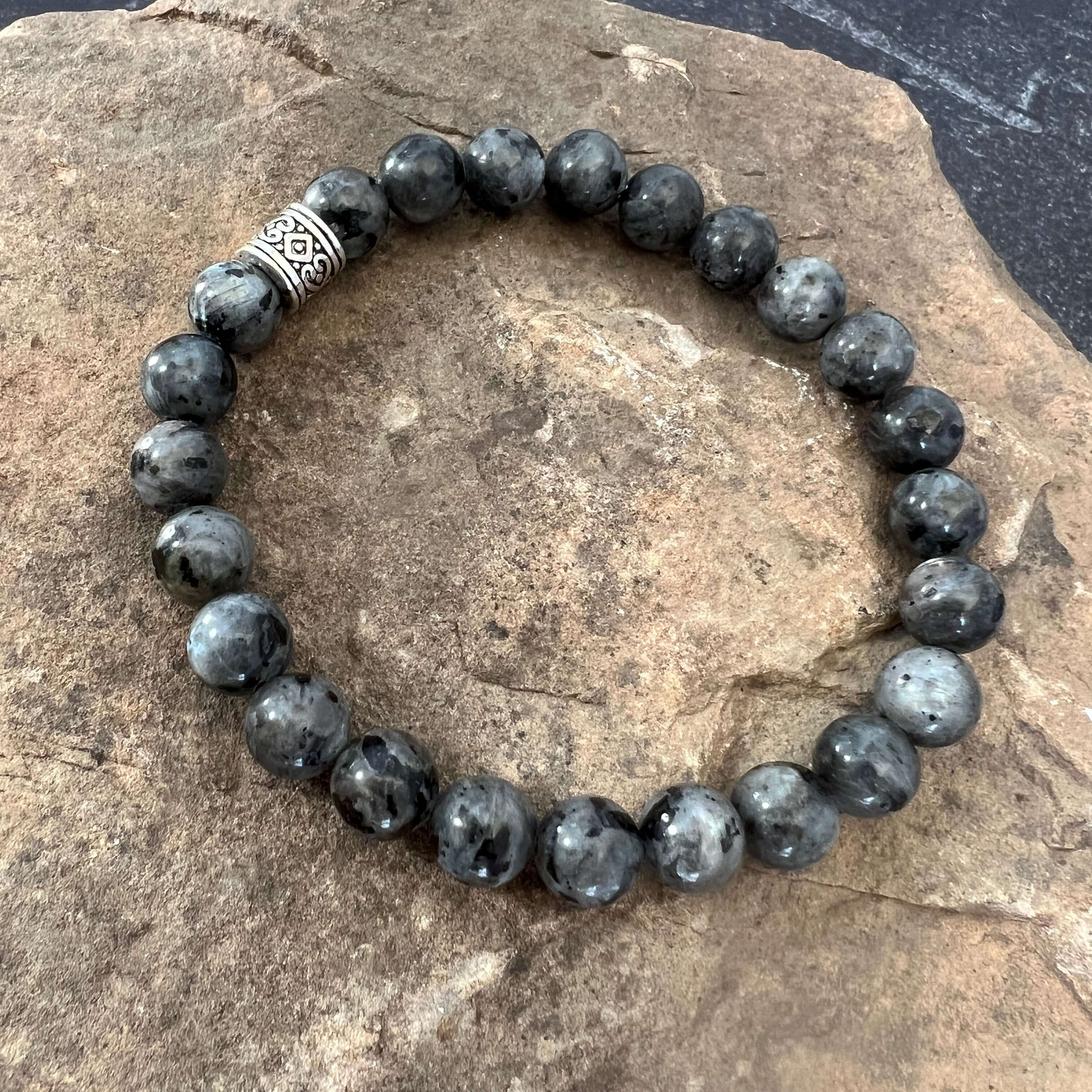 Larvikite Bracelet This bracelet is made with high-quality Larvikite stones which bring protection and a strong connection to nature to the wearer. Zodiac Signs: Aquarius. Chakras: Root and Third Eye. Handmade with authentic crystals & gemstones in Minnea