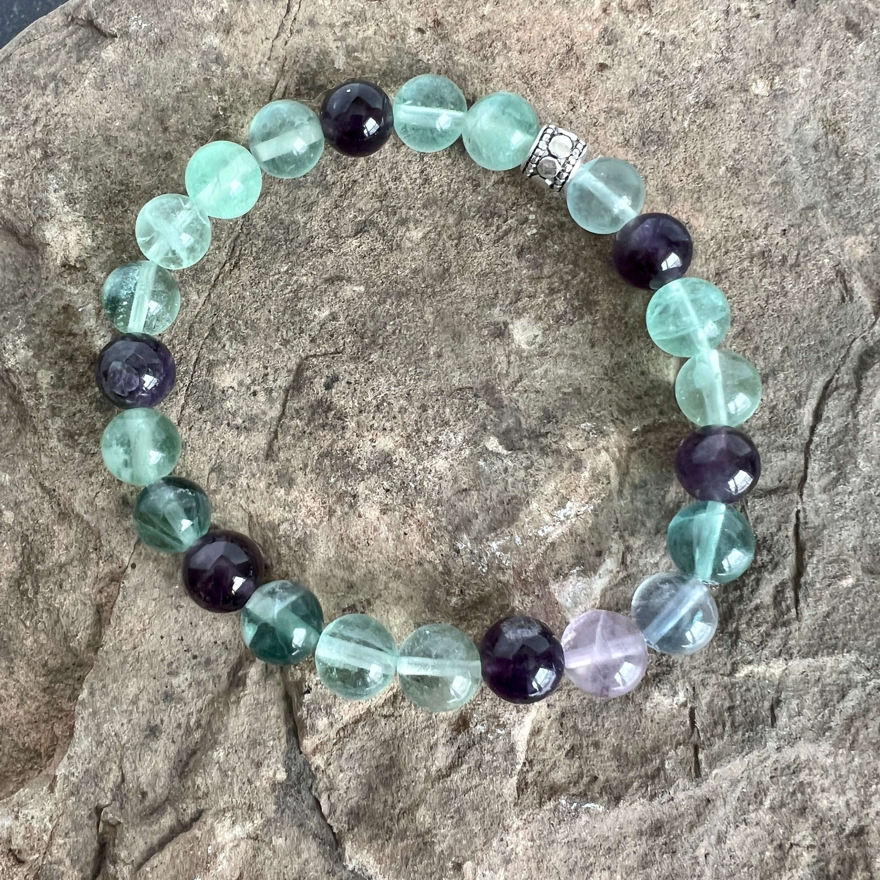 Fluorite and Amethyst Bead Bracelet This bracelet is made with high-quality Fluorite and Amethyst stones which bring stability, protection and awareness to the wearer. Zodiac Sign: Capricorn. Chakra: Heart. Handmade with authentic crystals and gemstones i