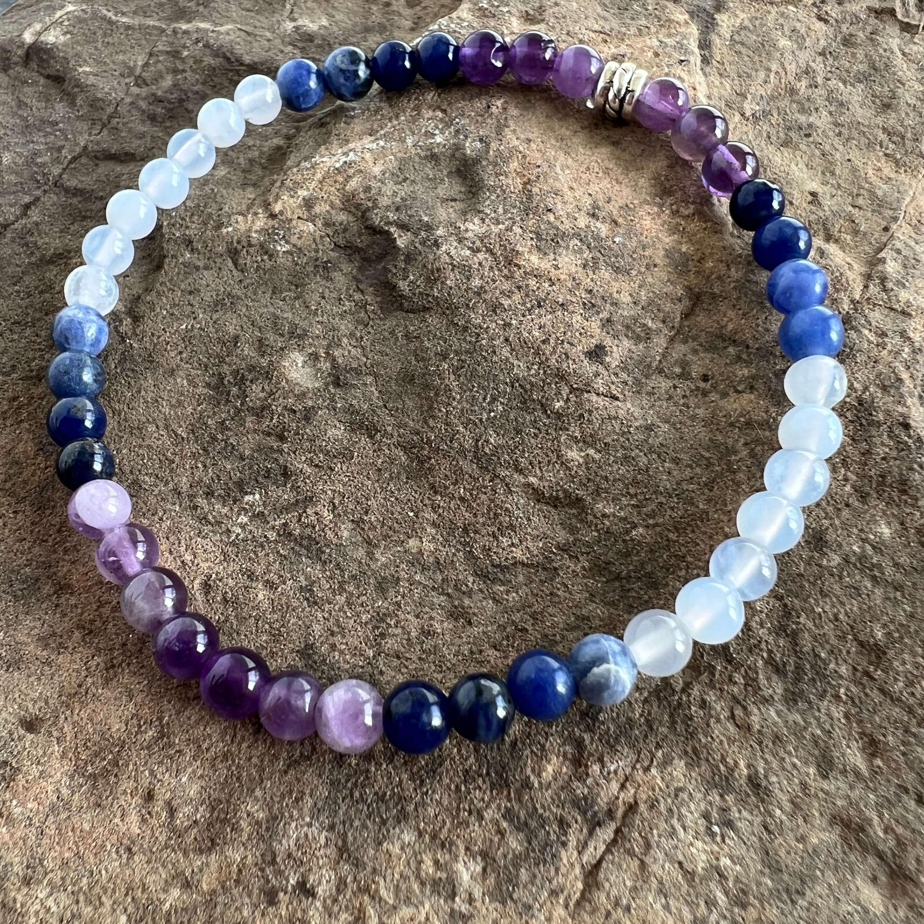 Twilight Bracelet This bracelet is made with Amethyst, Sodalite, and Blue Lake Agate which can heighten intuition and assist you to think logically and speak with clarity.