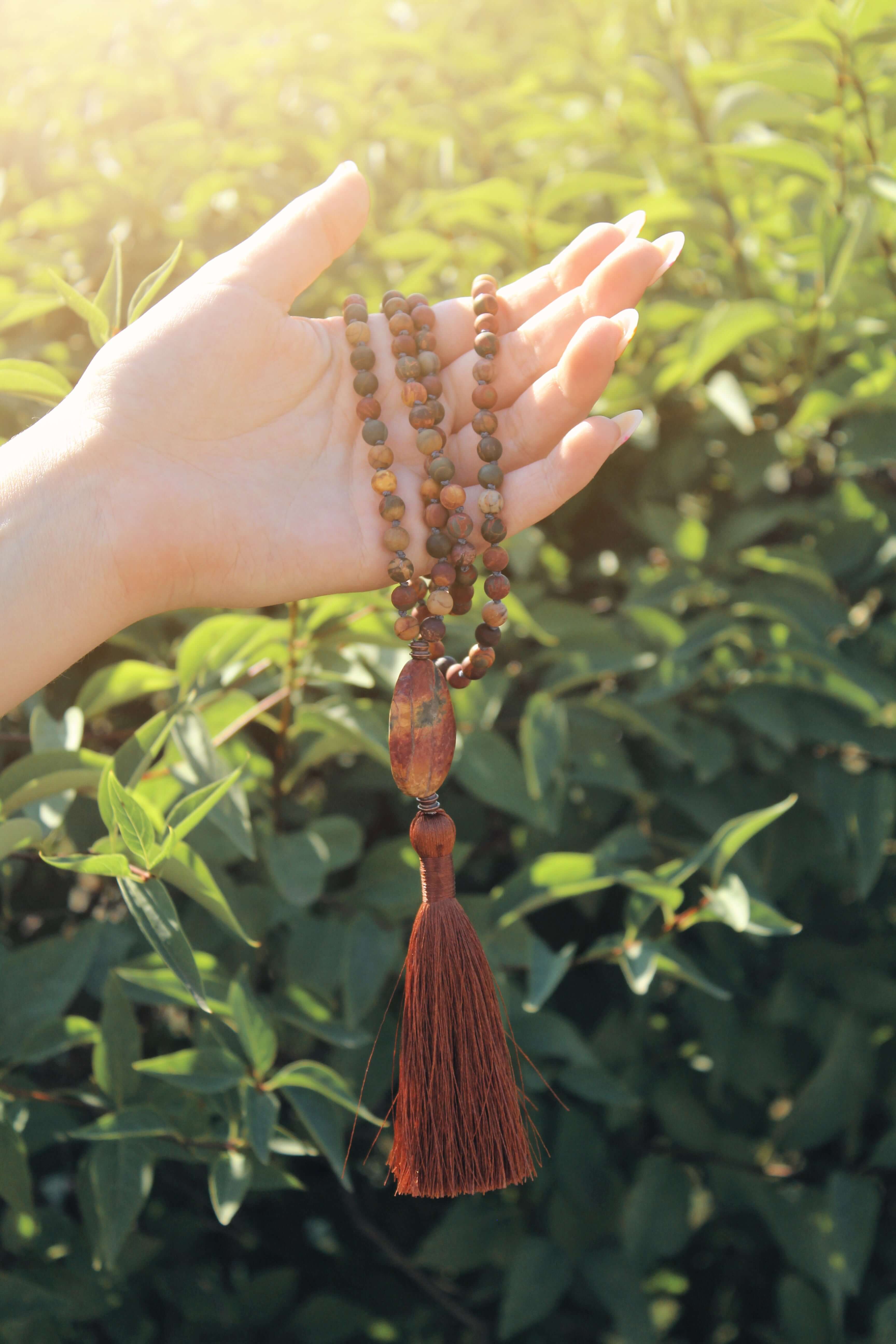 Red Earth Mala This mala is made with high-quality Red Creek Jasper gemstones which bring balance and grounding to the wearer. Zodiac Signs: Aries and Scorpio. Chakras: Root and Sacral. Handmade with authentic crystals & gemstones in Minneapolis, MN.